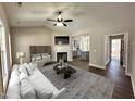 Comfortable living room featuring a fireplace, ceiling fan, and easy access to kitchen and entry way at 314 S Darden St, Kenly, NC 27542
