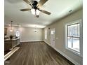 Bright open-concept living room featuring new floors and a ceiling fan at 315 S Maple Ave, Kenly, NC 27542