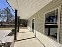 Inviting covered front porch with sturdy support columns, a view of the yard, and access to the front door at 315 S Maple Ave, Kenly, NC 27542