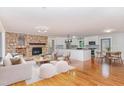 Spacious open-concept living and kitchen area with stone fireplace and hardwood floors at 4322 Russell Rd, Graham, NC 27253