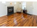 Cozy living room boasts hardwood floors, a fireplace, and comfortable seating at 5420 Golden Moss Trl, Raleigh, NC 27613