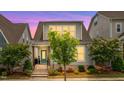 Charming two-story home with inviting front porch framed by lush landscaping under a purple sky at 5520 Advancing Ave, Raleigh, NC 27616