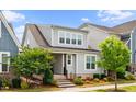 Beautiful two-story home featuring a covered front porch and professionally landscaped front yard at 5520 Advancing Ave, Raleigh, NC 27616