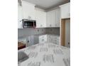 New kitchen featuring white cabinets, stainless steel appliances, and modern finishes at 64 Shay St, Angier, NC 27501