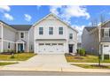 Charming two-story home with a two-car garage, landscaped yard, and blue sky at 669 Impala Trce, Wendell, NC 27591