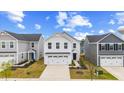 Beautiful two-story home with a two car garage and a well-manicured lawn on a sunny day at 669 Impala Trce, Wendell, NC 27591