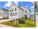 Lovely two-story home with a two car garage and a green lawn under a bright blue sky at 669 Impala Trce, Wendell, NC 27591