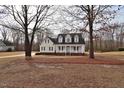 Attractive home framed by mature trees, featuring a classic front porch and well-maintained lawn at 730 Duck Pond Rd, Nashville, NC 27856
