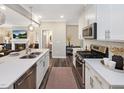 Well-equipped kitchen with white countertops, stainless appliances, and a view to living area at 810 Spoonbill Trl, Durham, NC 27703