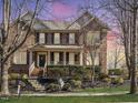 Charming brick home with a welcoming front porch, well-maintained landscaping, and mature trees at 109 Skywater Ln, Holly Springs, NC 27540