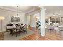 Open-concept dining room and living room featuring hardwood floors and neutral paint at 1100 Gaston Manor Dr, Durham, NC 27703