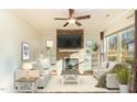 Cozy living room with a stone fireplace, built-in shelves, and neutral colored furniture at 1100 Gaston Manor Dr, Durham, NC 27703