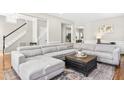 Spacious living room featuring a comfortable sectional sofa and stylish decor at 112 Bally Shannon Way, Apex, NC 27539