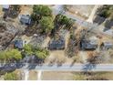 This aerial view shows the house in the landscape, including mature trees and a long road at 11254 Hwy Nc 50, Benson, NC 27504