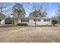 Inviting ranch home featuring a covered carport, freshly painted white brick, and black shutters, set on a spacious lot at 11254 Hwy Nc 50, Benson, NC 27504