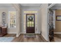 Welcoming foyer with a glass-paneled front door, hardwood floors, and ample natural light from the sidelight windows at 12344 Canolder St, Raleigh, NC 27614