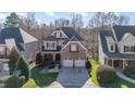 Charming brick and siding home with a two-car garage and well-manicured lawn at 12345 Beestone Ln, Raleigh, NC 27614