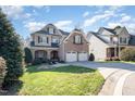 Charming brick and shingle home with a well-manicured lawn and a two-car garage at 12345 Beestone Ln, Raleigh, NC 27614