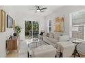 Cozy living room with modern furniture, natural light, and a view of the outdoor balcony at 1410 Joe Louis Ave, Raleigh, NC 27610