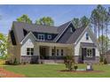 Attractive two-story house showcasing a covered porch and fresh landscaping at 15 Harvest View Way, Franklinton, NC 27525