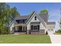 Beautiful home with a well-maintained lawn, two-car garage and appealing modern design at 15 Harvest View Way, Franklinton, NC 27525