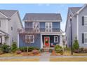 Beautiful two-story blue home with well-maintained landscaping and a welcoming front porch, nestled in a lovely neighborhood at 1520 Rhodeschool Dr, Wendell, NC 27591