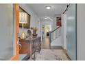Bright foyer with hardwood floors, a wooden dresser, and a view of the staircase, creating a warm and inviting entry at 1520 Rhodeschool Dr, Wendell, NC 27591