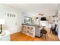 Cozy living room featuring hardwood floors, a fireplace, and large windows for natural light at 1807 S Mebane St, Burlington, NC 27215