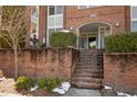 Inviting entryway with brick stairs, lush greenery, and clear signage at 201 Finsbury St # 302, Durham, NC 27703