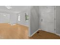 Sunlit living room boasts stylish flooring and neutral paint at 208 Hardwood Ridge Ct, Clayton, NC 27520