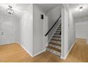 Bright hallway showcasing staircase featuring decorative tile risers at 208 Hardwood Ridge Ct, Clayton, NC 27520