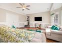 Cozy living room with a ceiling fan, warm wood floors, and ample natural light at 214 Woodcrest Ave, Smithfield, NC 27577
