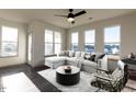 Bright living room with ample windows, modern furnishings and view of the neighborhood at 2300 Gathering Sq Ct, Fuquay Varina, NC 27526