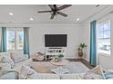 Bright living room with large windows, ceiling fan, and stylish furnishings at 2440 Tonoloway Dr, Raleigh, NC 27610