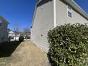 Neat side yard showing the well-kept lawn and mature shrubbery at 264 Steel Hopper Way, Garner, NC 27529