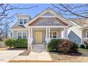 Inviting home featuring a welcoming front porch and a beautifully contrasting yellow door at 2715 Edmund St, Durham, NC 27705