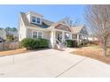 Home with a welcoming front porch, shingle detailing, and manicured landscaping and spacious driveway at 2715 Edmund St, Durham, NC 27705
