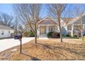 Home with a welcoming front porch, shingle detailing, a bright yellow front door and a mailbox with the house number at 2715 Edmund St, Durham, NC 27705