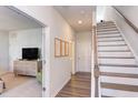 Bright hallway with staircase leading to upper levels, showcasing modern design and seamless transition to living spaces at 2929 Great Lawn Rd, Apex, NC 27502