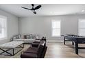 Spacious living room featuring a ceiling fan, sofa, chairs, and a foosball table at 3010 Garner Rd # 102, Raleigh, NC 27610
