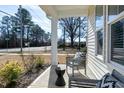 Cozy front porch with chairs and side table, ideal for relaxation and curb appeal at 3010 Garner Rd # 102, Raleigh, NC 27610