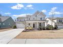 Stunning two-story home featuring a spacious two car garage and a charming covered front porch at 3021 Falco Field Ln, Fuquay Varina, NC 27526