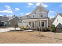 Lovely two-story home with a large covered front porch and a two car garage at 3021 Falco Field Ln, Fuquay Varina, NC 27526