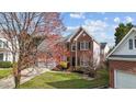 Charming two-story brick home with a well-manicured lawn, attached two-car garage, and mature landscaping at 3208 Marblewood Ct, Raleigh, NC 27604