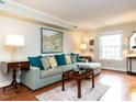 Comfortable living room with hardwood floors, a large sofa, and plenty of natural light at 3721 Browning Pl, Raleigh, NC 27609