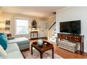 Comfortable living room featuring hardwood floors, neutral walls, and a staircase at 3721 Browning Pl, Raleigh, NC 27609