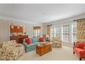 Bright living room featuring comfortable seating, large windows, and open access to other rooms at 3924 Sunset Maple Ct, Raleigh, NC 27612