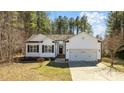 Charming single Gathering home featuring a 2-car garage, black shutters and attractive landscaping at 40 Paddle Wheel Ct, Franklinton, NC 27525