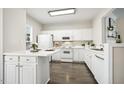 Well-lit kitchen featuring white cabinets and modern appliances at 405 Coral Creek Ln, Morrisville, NC 27560