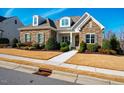 Beautiful home showcasing stone accents, a manicured lawn and a welcoming entrance at 44 Ashwood Dr, Chapel Hill, NC 27516